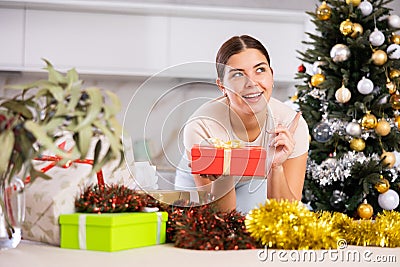 having gifts , girl in dreamy mood is thinking about New Year s party Stock Photo