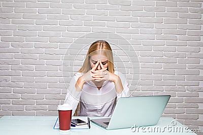 Having a headache after working really hard woman at office working place Stock Photo