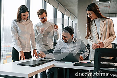 Having the meeting. Four people are working in the office together Stock Photo