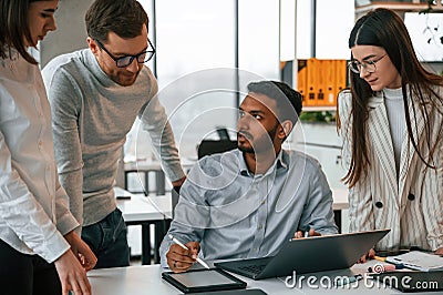 Having the meeting. Four people are working in the office together Stock Photo