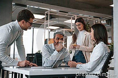 Having the meeting. Four people are working in the office together Stock Photo