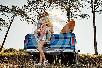 Having a road trip full of sight-seeing. an affectionate couple pulling over to admire the scenery while on a road trip. Stock Photo