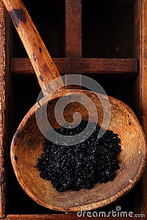 Hawaiian Black lava sea salt in rustic wooden spoon Stock Photo