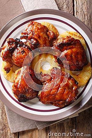 Hawaiian chicken huli huli with pineapple close-up. Vertical top Stock Photo