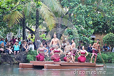 Oahu, Hawaii - 4/26/2018 - Hawaiian dancers performing while riding a canoe float at the Polynesian Cultural Center in Hawaii Editorial Stock Photo