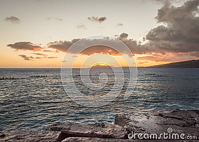 Hawaiian outrigger canoes at sunset Stock Photo