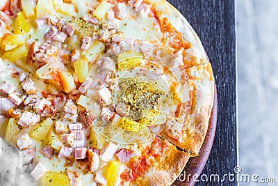 Hawaiian pizza is a Italian food which it made with tomato sauce, chopped pineapple, ham and cheese Stock Photo