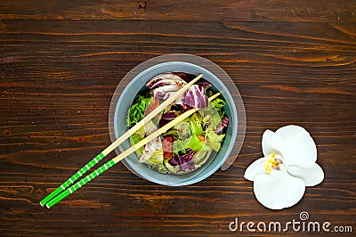 Hawaiian plate of salmon Poke with spicy. Homemade food. The concept of tasty and healthy meal.Copy space,wooden background Stock Photo