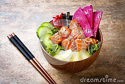 Hawaiian salmon poke bowl with seaweed, watermelon radish, cucumber, pineapple and sesame seeds. Copy space Stock Photo