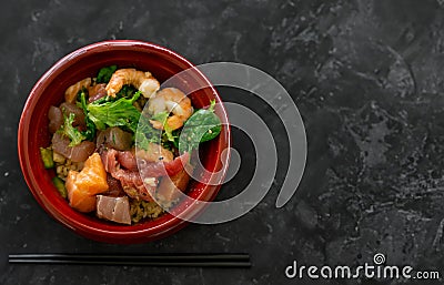 Hawaiian seafood poke bowl isolated on black table background Stock Photo
