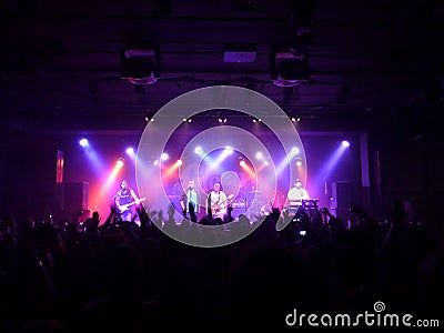 Hawaiian Style band the Green sing into mic while playing instr Editorial Stock Photo