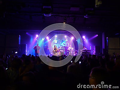 Hawaiian Style musician Kimie jams with guitar on stage while si Editorial Stock Photo