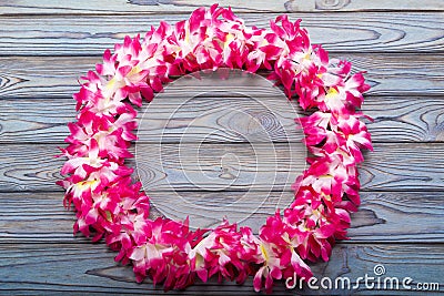 Hawaiian wreath on a wooden background. Stock Photo