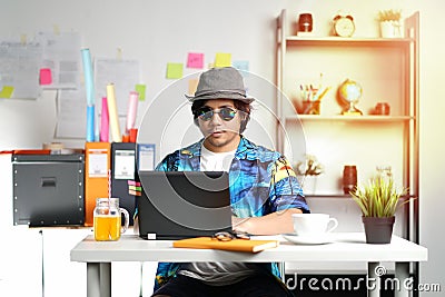 Hawaiian Young Man Working With Laptop on Summer Vacation Season Stock Photo