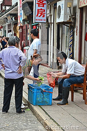 Hawkers and peddlers selling food and grocery in walking street Editorial Stock Photo