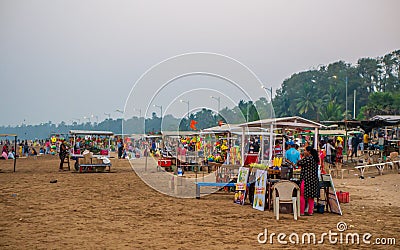 Hawkers selling street snacks and fast food on the Indian beach. Families spend leisure time on beaches Editorial Stock Photo