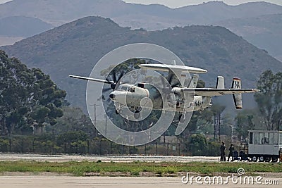 E-2 Hawkeye Twin Turboprop Airplane Landing at a Naval Base Editorial Stock Photo