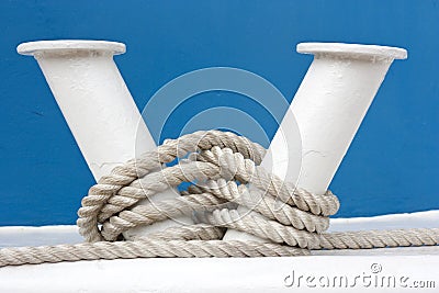 Hawser and white mooring bitt Stock Photo