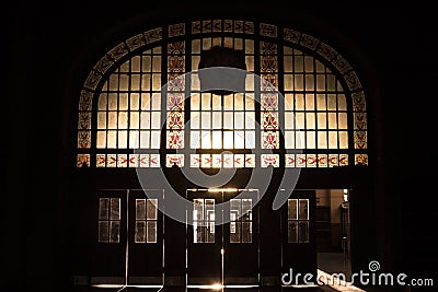 Haydarpasa train station`s main entrance into the light, the sun being filtered by art deco stained-glass Stock Photo