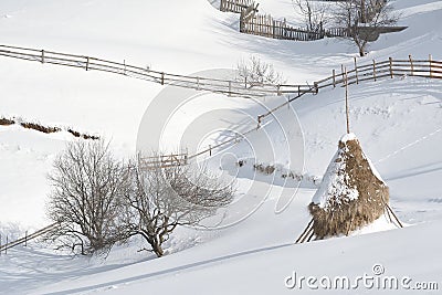 Haystack in winter mountains Stock Photo