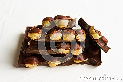 Hazelnut dark chocolate pieces tower on white background Stock Photo