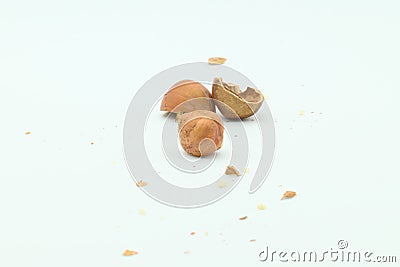 Hazelnut kernel and cracked nutshell behind Stock Photo