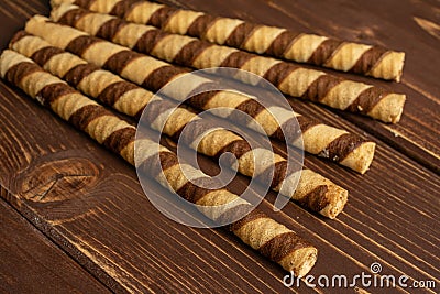 Hazelnut rolled wafer biscuit on brown wood Stock Photo