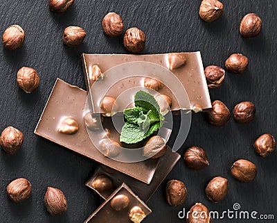 Hazelnuts, chocolate on a black board Stock Photo