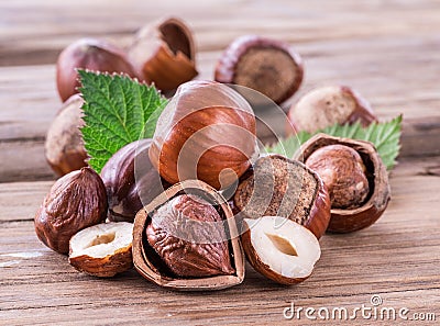 Hazelnuts and hazelnut leaves on the wooden table. Stock Photo