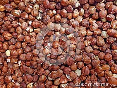 Hazelnuts heap top view. Flax nut texture. Nuts on market table close up photo. Hazelnuts fried without shell. Background. Stock Photo