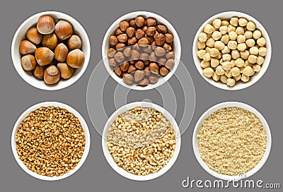 Hazelnuts, whole and processed nuts in white bowls Stock Photo