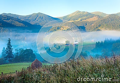 Hazy daybreak in mountain valley Stock Photo