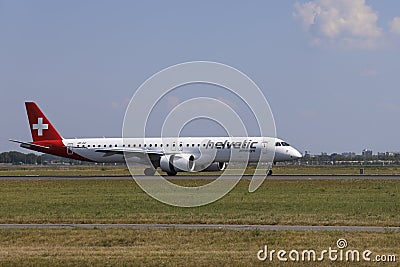 HB-AZI Helvetic Airways Embraer E195-E2 landing on the Polderbaan of Amsterdam Schiphol Airport Editorial Stock Photo