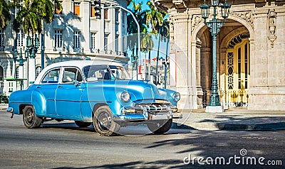 HDR - American blue classic car with white roof drived on the main street in Havana City Cuba - Serie Cuba Reportage Stock Photo