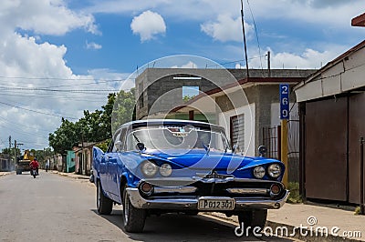 HDR Blue vintage car parked in the countryside from Cuba Editorial Stock Photo
