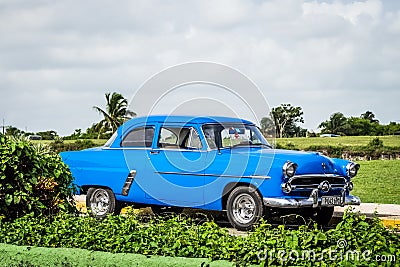 HDR Blue vintage car parked on the parking lot in Havana Cuba Editorial Stock Photo