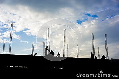 HDR effect of silhouette workers working at building construction side at sunset time Stock Photo