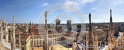 HDR panorama photo of white marble statues of Cathedral Duomo di Milano on piazza, Milan cityscape and the Royal Palace of Milan Editorial Stock Photo