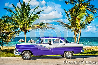 HDR - Parked american white blue vintage car in the front-side view on the beach in Havana Cuba - Serie Cuba Reportage Stock Photo