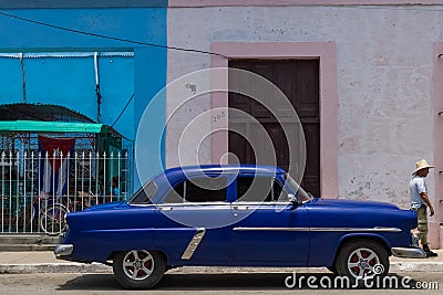 HDR parked blue american classic car in Cuba with a latino Editorial Stock Photo