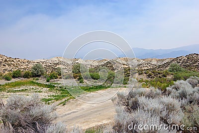 HDR Photo. Desert hills and brush on a smoky, hazy day at Rye Patch Reservoir, outside of Lovelock, Nevada Stock Photo