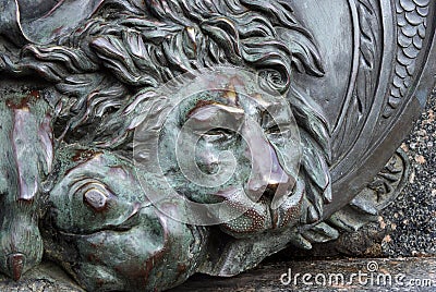 Head of a bronze lion. bronze sculpture of a sleeping lion on the monument of glory in Poltava, Ukraine Stock Photo