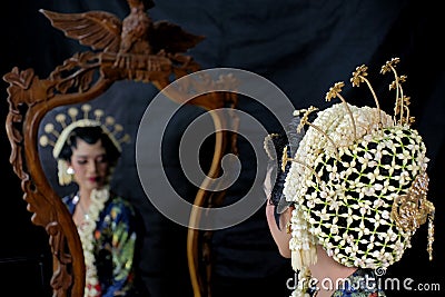 Head bun with jasmine flower ornaments on the makeup of Javanese women Editorial Stock Photo