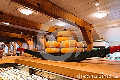 The head of cheese on the shelves of warehouse in netherlands open sky museum Zaanse schans. Production of Dutch cheese Editorial Stock Photo