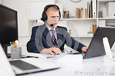Head of the company conducts online negotiations with business partners in headphones Stock Photo
