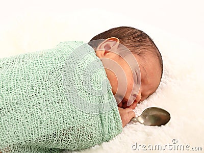 Cute baby boy born with silver spoon Stock Photo