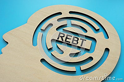 Head with labyrinth and inscription REBT Rational Emotive Behavior Therapy. Stock Photo