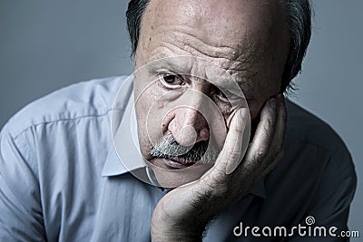 Head portrait of senior mature old man on his 70s looking sad and worried suffering Alzheimer disease Stock Photo