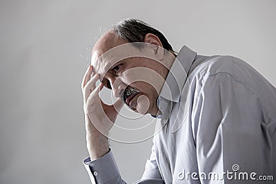 Head portrait of senior mature old man on his 60s looking sad and worried suffering pain and depression in sadness face expression Stock Photo