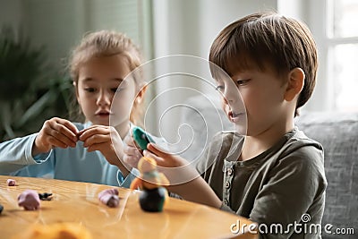 Happy cute small children siblings involved in handmade activity. Stock Photo